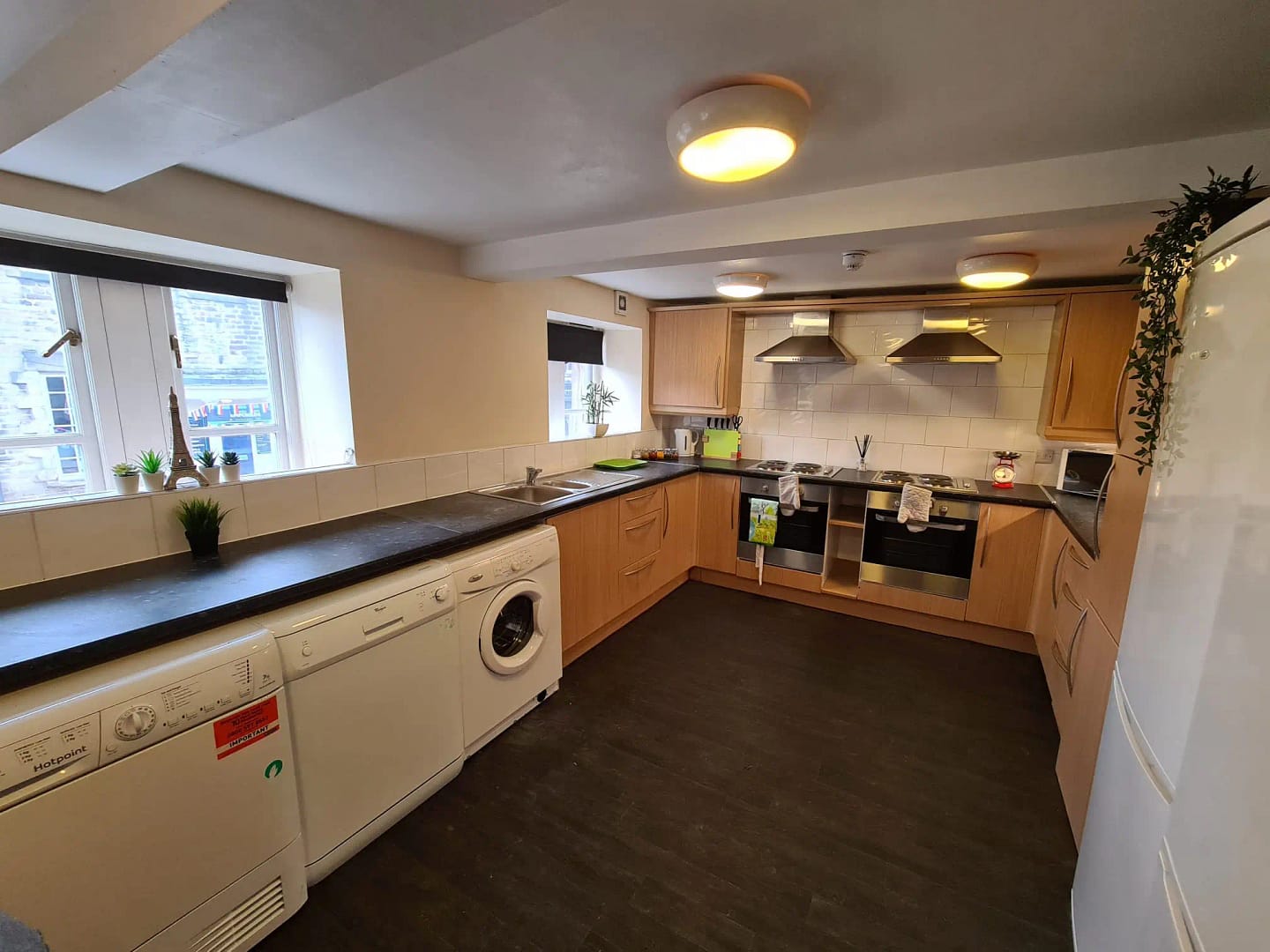 Luxury student accommodation Lancaster university homes approved student kitchen A modern, fully-equipped kitchen in a Bayt Lancaster student accommodation property, featuring high-spec appliances and a communal dining area.