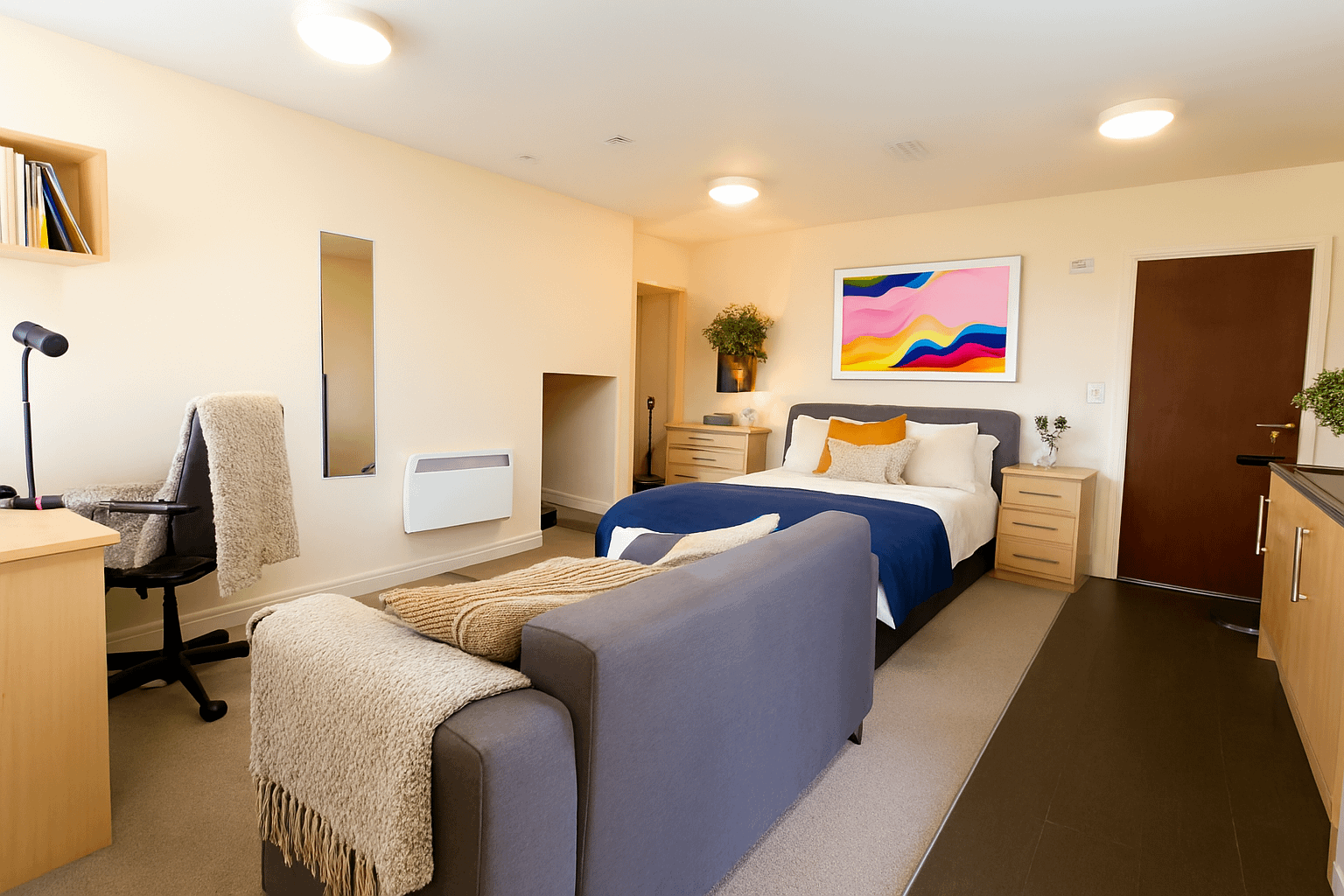 Luxury student studio apartment at Bayt Student Accommodation in Lancaster City Centre, featuring a premium double bed, plush sofa, and modern kitchenette
